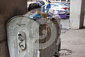 Outdoor trash bin with food waste. Not sorted garbage, yard, stench, filth