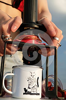 Outdoor travel coffee brewing in a manual espresso maker close-up