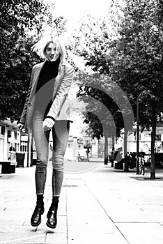Outdoor urban female portrait, black and white. Fashion model. Young woman posing in Milan streets against.