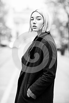 Outdoor urban female portrait, black and white. Fashion model. Young woman posing in Milan streets against Arch of Peace Arco