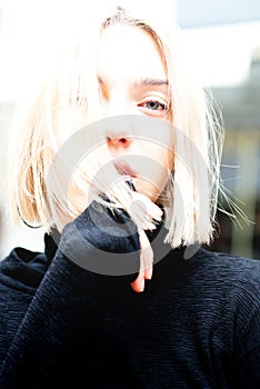 Outdoor urban female portrait, soft focus, high key. Fashion model. Young woman posing in Milan streets. Beautiful caucasian girl