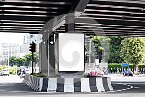Outdoor vertical LED display billboard on crossroad with mock up white screen. Clipping path for mockup