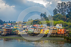 Outdoor view of colorful houses on stilts palafitos in the horizont located in Castro, Chiloe Island