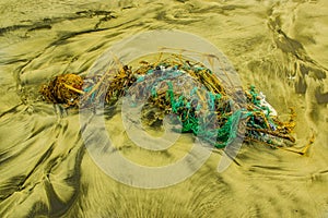 Outdoor view of fishing net and ropes garbage in the beach, every day, waste accumulates on the beach of Atlantic west