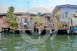 Outdoor view of floating poor house on the Chao Phraya river. Thailand, Bangkok