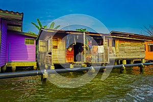 Outdoor view of gorgeous floating wooden house with a pipeline on the Chao Phraya river. Thailand, Bangkok