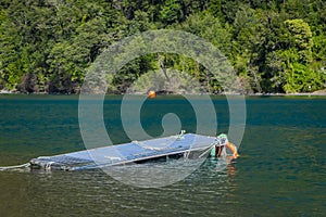 Outdoor view of metallic strcuture in the shore in the lake of todos Los Santos, Region in Chile