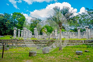 Outdoor view of some collumns and ruins located in Chichen Itza in Mexico