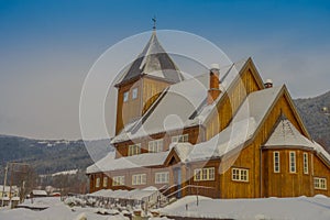 Outdoor view of the Stave Church partial covered with snow during a heavy winter season in Gol