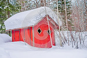 Outdoor view of traditional Norwegian mountain red cabins of wood covered with snow in a winter season in Norway