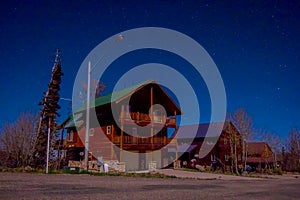 Outdoor view of wooden house in a gorgeous night photography Bryce Canyon with moonlight and sky stars