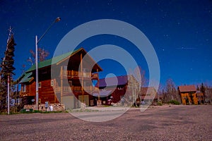 Outdoor view of wooden house in a gorgeous night photography Bryce Canyon with moonlight and sky stars