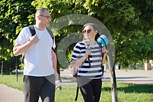 Outdoor walking man and woman, talking people middle-aged couple