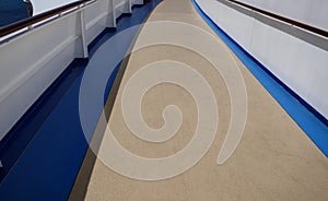Outdoor walking path on deck of cruise ship on sunny day