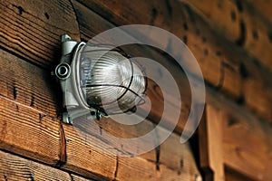 Outdoor wall light on lodging cottage wooden door photo