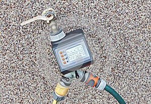Outdoor water tap with water timer for automating irrigation photo