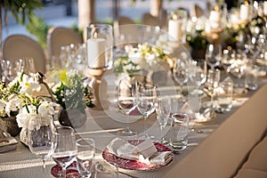 Outdoor wedding celebration at a restaurant. Festive table setting, catering. Wedding in rustic style in summer