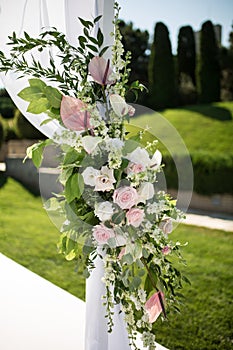 Outdoor wedding ceremony. Wedding chuppa decorated with fresh flowers