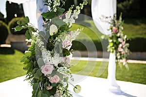 Outdoor wedding ceremony. Wedding chuppa decorated with fresh flowers