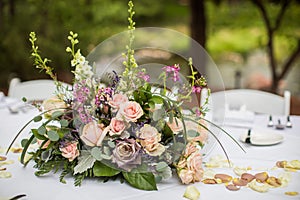 Outdoor wedding reception centerpiece featuring a vibrant display of flowers