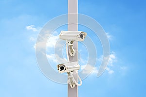 Outdoor white CCTV on pole with blue sky background and copy space