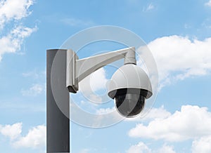 Outdoor white CCTV on pole with blue sky background and copy space