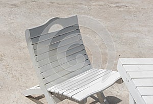 The outdoor white wooden chair is a stylish and inviting addition to any outdoor space, combining the charm of wood with the