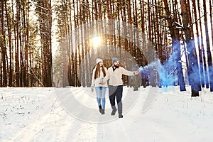 Outdoor winter cold sensual photo of a young happy beautiful couple in love walking in the forest