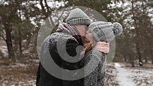 Outdoor winter forest shot of young wedding couple walking and having fun holding hands in snow weather pine forest