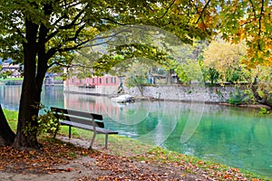 Outdoor wood chair in front of the river, empty bench, rural atmosphere