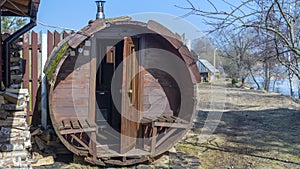 Outdoor wooden barrel sauna. Mobile bath in the form of a wooden barrel. Finnish SPA, relax holidays .Relax concepts.