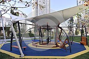 Outdoor wooden public playground equipment with climbing steps and slide.