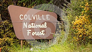 The Outdoor Wooden Roadside Sign Says Colville National Forest