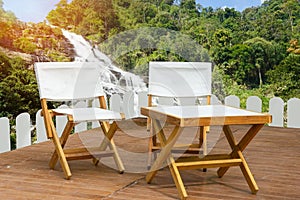 Outdoor wooden Table set  in the Camping area at Natural Parkland and mountain and waterfall views background