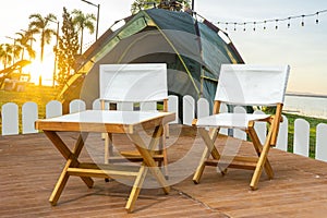 Outdoor wooden Table set with Field Tents group in the Camping area at Natural Parkland and river views background