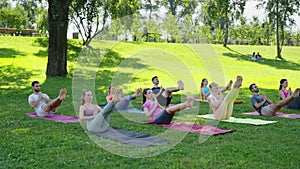 Outdoor yoga balance: group holds boat pose