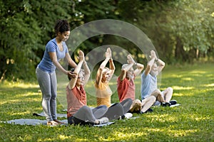 Outdoor Yoga Class. Group of smiling senior people training together outdoors