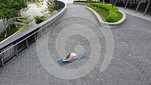 Outdoor Yoga in public spaces in Singapore by Asian Chinese Female Yogi