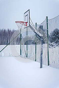 Outdoors basketball court covered with snow in winter