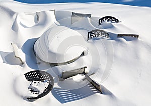 Outdoors garden table and chairs buried in snow drift