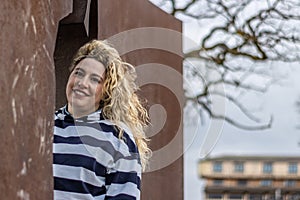 Outdoors lifestyle fashion portrait of happy stunning blonde girl.