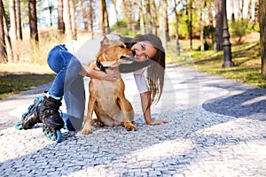 Outdoors lifestyle portrait of a beautiful girl wearing roller s