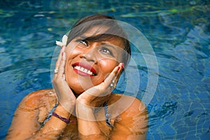 Outdoors lifestyle portrait of middle aged 40s or 50s attractive and happy Asian Indonesian woman in biking enjoying holidays at