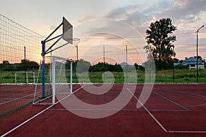 Outdoors mini football and basketball court with ball gate and basket surrounded with high protective fence