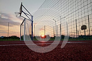 Outdoors mini football and basketball court with ball gate and basket surrounded with high protective fence