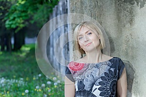 Outdoors park portrait of mature woman at green alley background