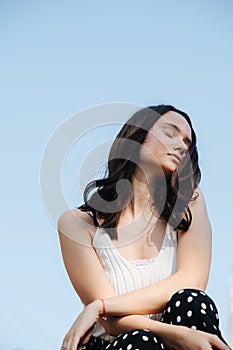 Outdoors portrait of beautiful woman with vitiligo over blue sky