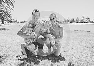 Outdoors Portrait of happy caucasian family of mum dad, boy and little girl having fun in the park