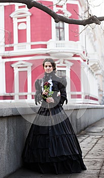 Outdoors portrait of a lady with the red rose