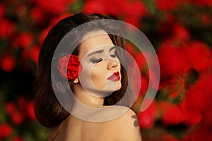 Outdoors portrait of Natural Beauty woman in red roses. Sensual